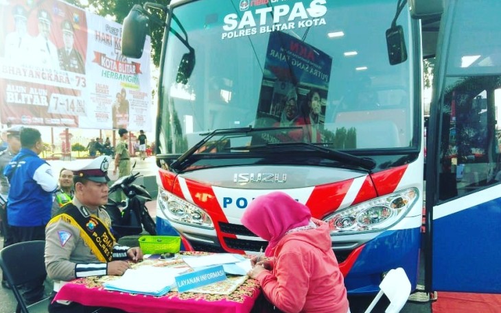 Petugas Kepolisian Satlantas Polres Blitar Kota Saat Melayani Masyarakat Mengurus SIM di Layanan Mobil SIM Keliling
