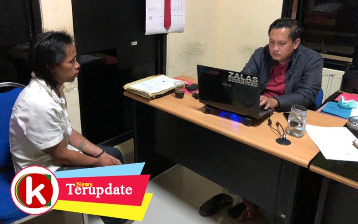 Tersangka (kiri) saat diperiksa penyidik