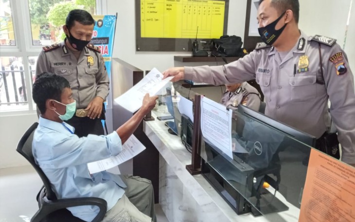 Kepala SPKT Polres Batang, Iptu Herry Rubiono memberikan formulir kepada petugasGedung Pelayanan Kepolisian, Polres Kabupaten Batang, Jumat (16/10/2020).  