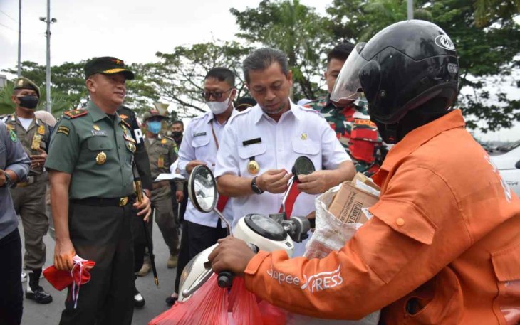Wagub Kaltim dan Danrem 091/ASN saat membagikan bendera merah putih 