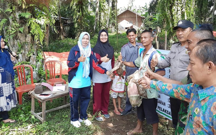 Bhabinkamtibmas Polsek Seginim saat Dampingi Pemberian Itik Petelur Gratis Untuk Warga