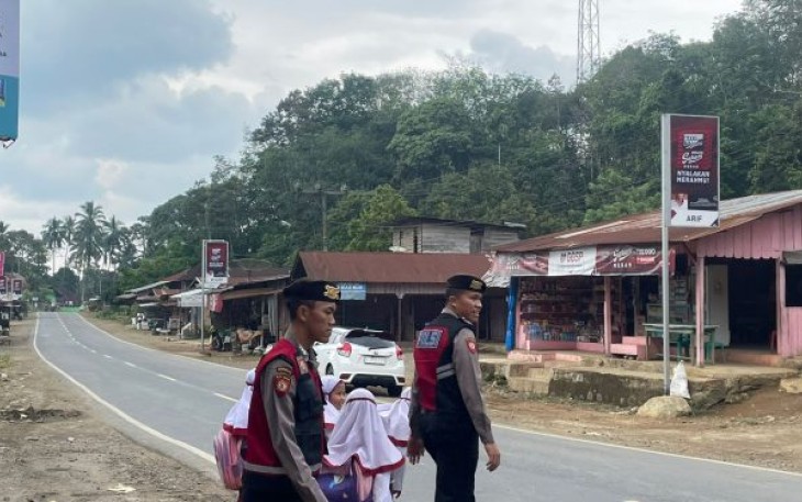 Personel Sat Samapta Polres Tapsel saat menyeberangkan anak-anak Sekolah agar lebih aman.