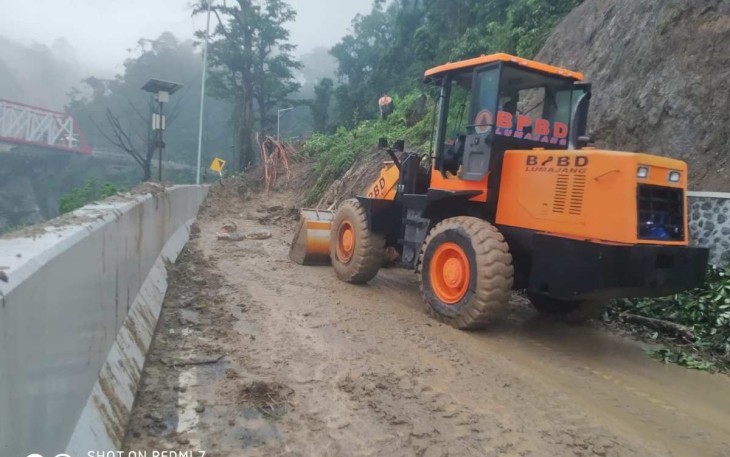 Buldoser saat membersihkan material pasca longsor di KM59 tol Lumajang -Malang, Sabtu (8/7)