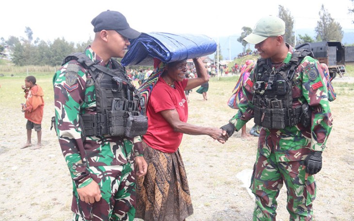 Satgas Yonif 330 Tri Dharma saat Bagikan Terpal Untuk Warga Kampung Bazemba