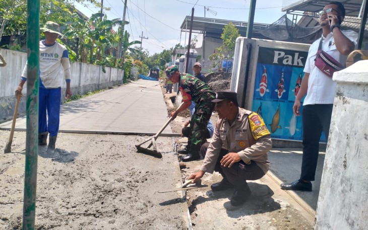 Babinsa Koramil 05/Wungu Sertu Edi Purwanto bersama masyarakat melaksanakan kegiatan pengecoran jalan (rabat beton) di RT 20 RW 02 Desa Sidorejo, Kecamatan Wungu, Kabupaten Madiun, Selasa (9/1/2024)