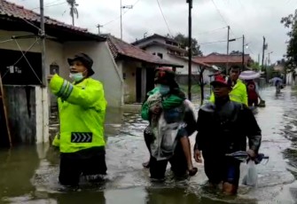 Personel Satuan Sabhara Polres Pekalongan Kota menyisir banjir di Kota Pekalongan, Sabtu (6/2/2021).