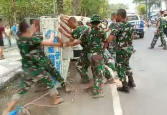 Evakuasi mobil warga  terguling dibantu prajurit Alugoro