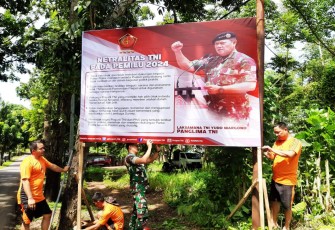 Personil Kodim 1310/Bitung saat memasang baliho panglima TNI