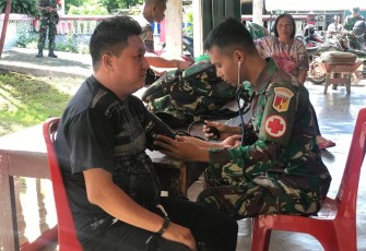 Tim kesehatan Satgas TMMD Ke-116 Kodim 1310/Bitung saat berikan pelayanan kesehatan kepada warga