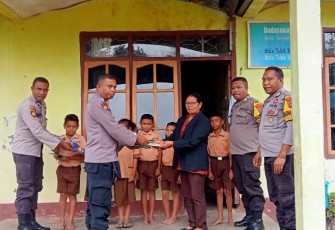 Kanit Binmas Polsek Soa Aipda Abraham memberikan buku pelajaran 