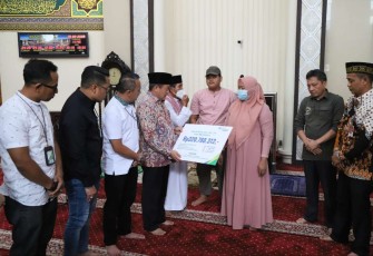 Kapuspen Kemendagri Benni Irwan saat memberikan santunan BPJS Ketenagakerjaan 