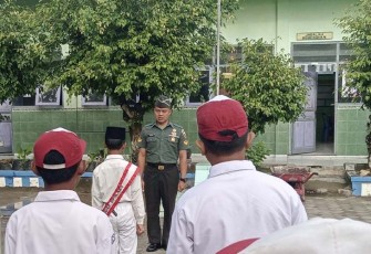 Babinsa Koramil Kedunggalar Kodim 0805/Ngawi Sertu Nurmaki saat menjadi Inspektur Upacara (Irup)