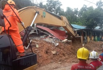 Petugas gabungan dibantu alat berat melakukan upaya pencarian dan pertolongan terhadap korban tanah longsor di Kota Batam, Kepulauan Riau, Senin (13/1)