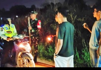 Serka Agus Supraptono, Bintara Pembina Desa (Babinsa) Komando Rayon Militer dan (Koramil) 03/Binut, saat melaksanakan monitoring kegiatan dalam menjaga di lingkungan bersama Linmas, Ketua RT serta masyarakat, Minggu (14/09/2025) malam.