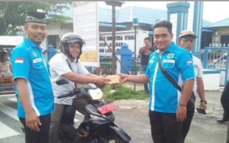 Personil Satnarkoba Polres Asahan saat membagikan takjil kepada pengendara roda 2 di Kota Kisaran. Rabu, (15/5/2019).