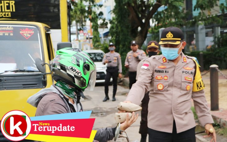 Kapolresta Barelang AKBP Purwadi Wahyu Anggoro SIK MH saat berikan nasi bungkus kepada pengendara motor di Jalan Engku Putri Batam Center