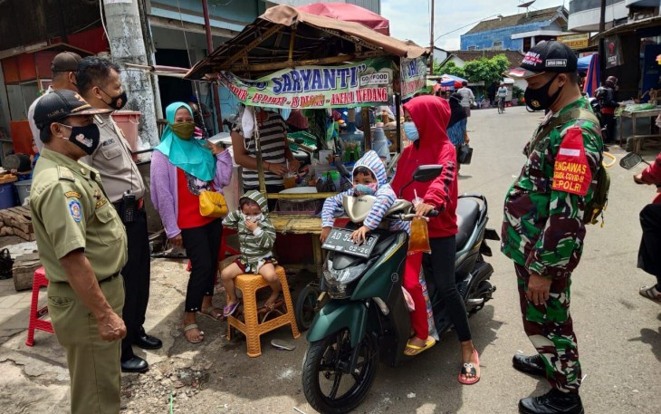 Sertu Hendri Babinsa Koramil 02/Nguter Kodim 0726/Sukoharjo melaksanakan sosialisasi Pemberlakuan Pembatasan Kegiatan masyarakat (PPKM)
