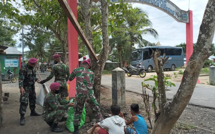 Prajurit Yonmarhanlan VIII Bitung saat melaksanakan kegiatan bersih-bersih bersama warga di kampung Ambon kecamatan Likupang timur