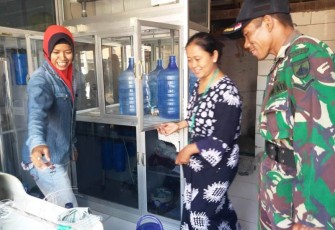 Julekha pemilik Depot Air Isi Ulang saat melayani pembeli Air Isi Ulang Desa Jatimulya