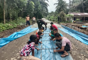 Anak-anak Nagori Puli Buah Antusias Ikut Pasang Besi Cor Jalan