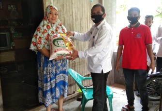 Kepala BNNK Lhokseumawe AKBP. Fakhrurozi saat memberikan sembako kepada warga yang kurang mampu.