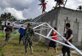Satgas TMMD saat bantu warga pasang rangka baja atap Warga