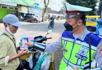 Anggota Unit Kamsel Satlantas Polres Karanganyar saat memberikan sosialisasi keselamatan lalu lintas kepada seorang pedagang keliling, Rabu (6/7/2022).