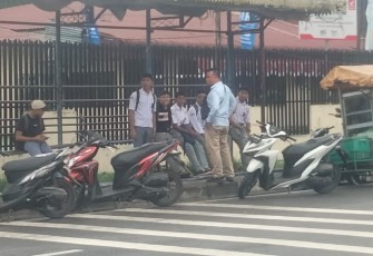 Personel Polsek Medan Kota saat membubarkan pelajar yang nongkrong di halte bus, Kamis (17/8)