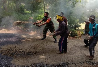 Babinsa Segulung Sertu Budi, disela kesibukannya membantu pengaspalan jalan di lingkungan Dusun Glatik RT 24, RW 09 Desa Segulung, Kecamatan Dagangan, Kabupaten Madiun, Sabtu (16/9/2023).