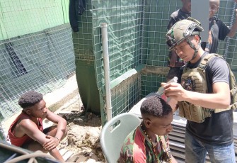 Satgas melaksanakan kegiatan “Barber Shop TNI” dengan mencukur rambut 10 orang siswa SD 03 Mayuberi.
